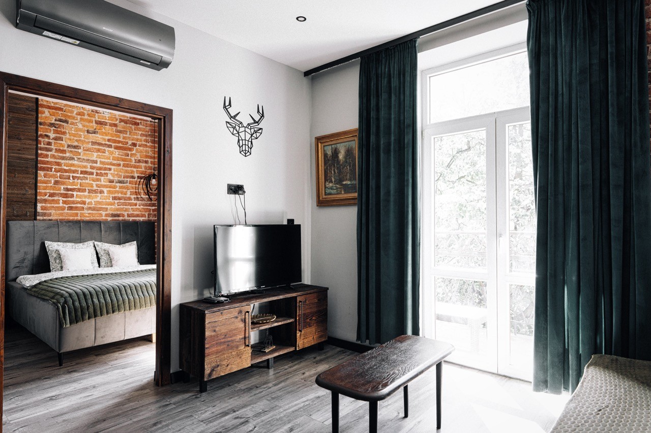 Apartament Watra w Zakopanem – salon z sofą, telewizorem i wejściem do sypialni